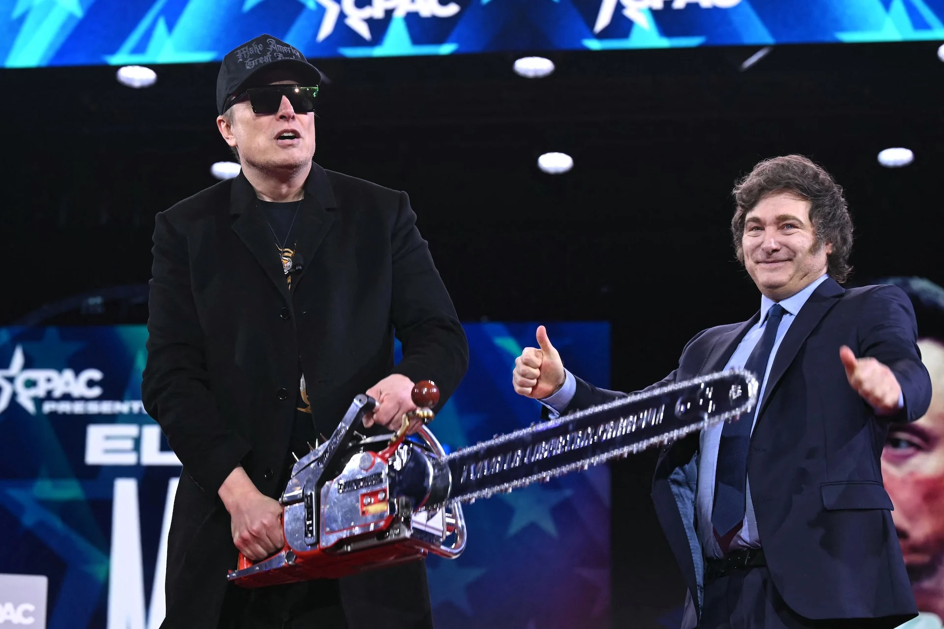 Elon Musk: Salesman, Not Optimist? Davos Deception 6 Elon Musk (L) holds a chainsaw alongside Argentine President Javier Milei during the annual Conservative Political Action Conference (CPAC) at the Gaylord National Resort & Convention Center at National Harbor in Oxon Hill, Maryland, on February 20, 2025.