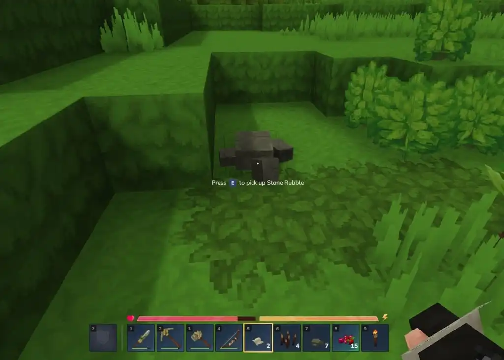Hytale Rubble: Find It & Get It! 6 A screenshot from Hytale showing pixelated grass. On top of the green grass is blocky grey stone
